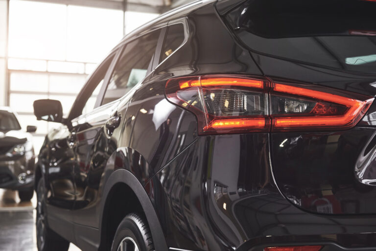 The back headlights of a black luxury car